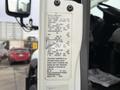 A 2013 International Workstar 7500 with visible vehicle specifications and information label on its door