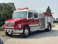 1999 Freightliner FL80 fire truck with red and silver color scheme featuring a water pump and emergency lights on top
