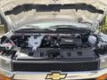 The image shows the engine compartment of a 2020 Chevrolet Express with various components including the engine battery and wiring visible under the hood