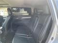 Interior of a 2018 Toyota Highlander featuring black leather seats and a spacious layout designed for passenger comfort