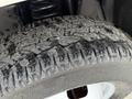 Close-up of a rugged tire tread from a 2015 Ford F-350 showing deep grooves and a textured surface suitable for off-road conditions