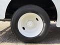 Close-up of a white wheel and tire from a 2017 Freightliner MT45 showcasing the tread and rim details