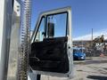 A 2008 International 7500 truck with an open driver's side door showing the interior panel and controls