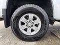Close-up of the wheel and tire of a 2018 Chevrolet Colorado featuring a silver alloy rim with a bowtie emblem and a Toyo tire with rugged tread design