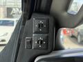 Control panel for the side mirrors in a 2017 Chevrolet Express featuring directional buttons and a toggle switch