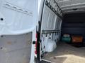 A 2016 Mercedes-Benz Sprinter van with an open rear door revealing a spacious empty cargo area and interior walls designed for storage and customization