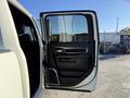The image shows the open driver's side door of a 2023 RAM 3500 featuring a sleek interior design and modern controls