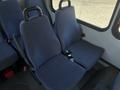 Two blue upholstered passenger seats with seatbelts in the interior of a 2017 Chevrolet Express van
