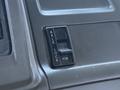 Close-up of an axle lock switch in a 2004 Sterling LT9500 truck interior featuring a black toggle switch labeled AXLE LOCK