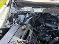 A close-up view of the engine compartment of a 2014 Ford F-150 featuring various components including the battery wiring and engine parts