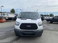 A 2017 Ford Transit van facing forward with a white exterior and a black grille