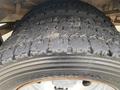Close-up of a worn tire on a 2015 Ford F-550 showing visible tread wear and damage