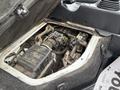 A 2008 Suzuki Carry with the engine exposed showing various components including the air intake and wiring in a dirty engine bay
