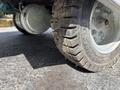 A close-up of a rugged tire of a 2023 Bitimec SC415 showcasing its tread pattern and metallic wheel rim