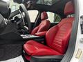 Interior of a 2023 Alfa Romeo Giulia featuring red leather seats with a sporty design and a modern dashboard layout