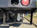 Close-up of the underside of a 2013 International 7500 showing the tail light and control levers mounted on a black frame