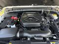 Engine compartment of a 2021 Jeep Wrangler showing the engine block battery and various components arranged neatly