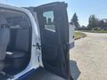 A 2017 Chevrolet Colorado with the driver's side door open revealing the interior featuring gray seats and a spacious cabin