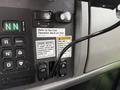 Dashboard controls of a 2016 Peterbilt 348 including buttons for engine restart and PTO control along with various operational decals