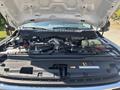 Engine compartment of a 2023 Ford F-350 SD showing various components including the engine block and fluid reservoirs