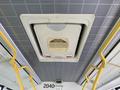 Ceiling-mounted air conditioning unit inside a 2016 Grande West Vicinity bus with yellow grab handles on either side