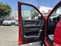 A 2013 RAM 2500 truck with its driver's side door open showcasing the interior features such as the door panel and controls