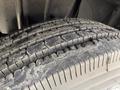 Close-up of a heavily treaded tire from a 2014 International TerraStar showing wear and dirt on the surface