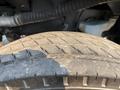 Close-up of a worn tire tread on a 2016 Freightliner M2 106 showcasing visible grooves and dirt accumulation