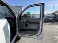 A 2021 Ford F-250 SD with an open driver side door showcasing the interior door panel and handle