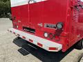 A red 2007 GMC C4500 TopKick truck with a silver step bumper and rear lights visible on the back of the vehicle