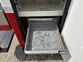 A metallic storage drawer partially open on a 2012 International 7300 Workstar vehicle showing a textured interior surface