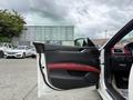 A 2016 Maserati Ghibli with a partially open door featuring a black and red interior design and modern controls visible inside the vehicle