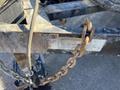 A rusty chain attached to a 2015 Snake Trailer with a warning label on the side