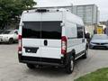 A white 2020 RAM Promaster van viewed from the rear with a black stripe along the bottom and rectangular taillights