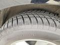 Close-up of a tire from a 2017 Ford Edge showcasing tread patterns and details on the sidewall indicating rotation direction