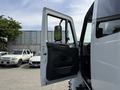 A 2011 International 4300 truck with an open driver-side door showcasing the interior and side mirror