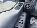 Close-up of the control panel in a 2015 Ford F-550 featuring window controls and various knobs for vehicle settings