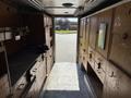 Interior view of a 2009 Morgan Olson Workhorse W62 with wooden storage cabinets and a work surface visible