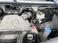 The engine compartment of a 2025 Mercedes-Benz Sprinter showing various engine components and fluids with a Mercedes logo on the cover