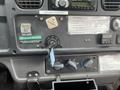 The dashboard of a 2007 Freightliner B2 featuring a radio climate control knobs and a key ignition with a key attached