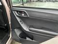 Interior view of the driver's side door panel of a 2016 Subaru Forester featuring controls for windows and door locks