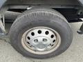 A close-up of a wheel and tire from a 2023 Ford Transit showing the tire tread and wheel rim with visible lug nuts