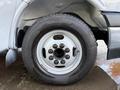 A close-up view of the wheel and tire of a 2019 Chevrolet Express featuring a white rim and multiple lug nuts