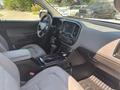 Interior of a 2017 Chevrolet Colorado showing front seats center console and dashboard with infotainment system and shifter