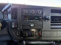 Dashboard of a 2019 Chevrolet Express featuring a radio with buttons and knobs control panel with additional switches and gauges
