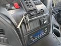 Close-up of the dashboard of a 2012 Autocar Xpert showing various controls switches a key and a digital display