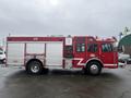 A red 2006 E-One fire truck with a large storage compartment on the side and emergency lights on top displaying the number 1 and the text C911