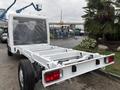 2023 RAM Promaster 3500 chassis cab with a white exterior showing the frame and rear lights without the cargo area
