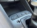 Close-up of the control panel in a 2018 Kia Rio5 featuring buttons for heated seats and drive modes