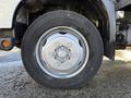 A close-up of a 2014 Hino 195 truck wheel showing a silver rim and a black tire with visible tread patterns